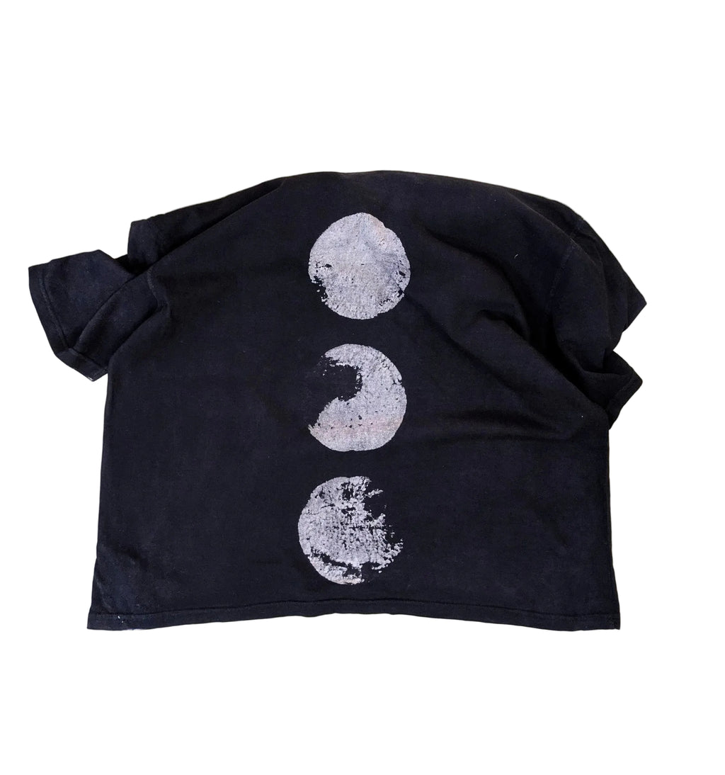 Black fabric with white moon phases printed on a beige background